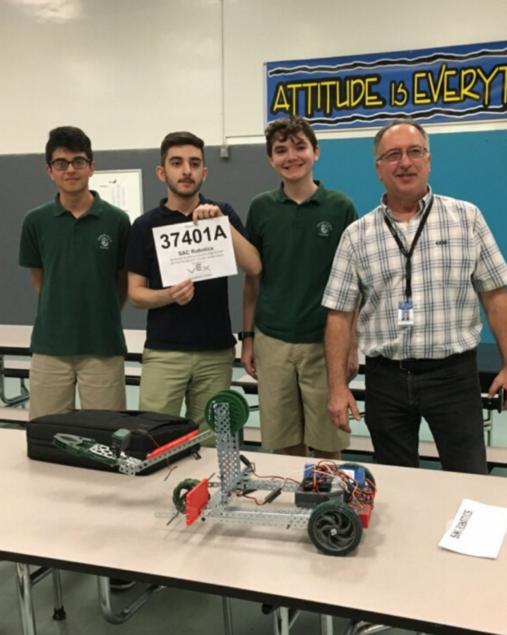 Our robotics team stands proudly behind their creation.