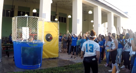 The crowd erupts into cheers after a softball player is the first to dunk Mr. G.
